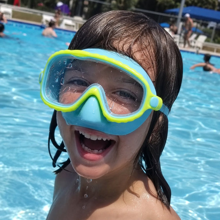 Child smiling in a Lakeday enclosed-nose swim mask at the pool